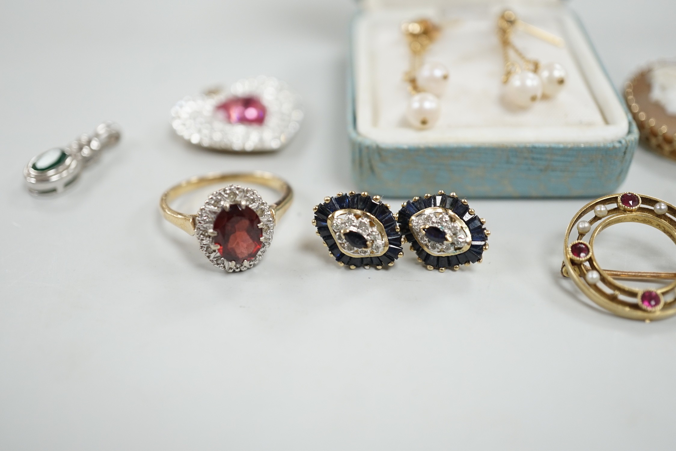 Mixed jewellery including two 9ct and gem set cluster rings and a 15ct, ruby and seed pearl set circular brooch, a yellow metal mounted oval cameo shell brooch, a pair of 9ct gold and gem set cluster ear studs, a 9ct whi